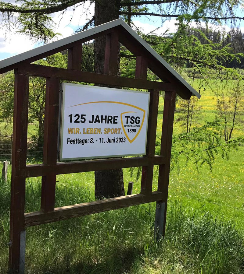 Ein Schild mit 125 Jahren Jubiläum am Ortseingang von Helberhausen